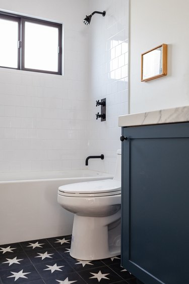 Blue and white star patterned tile bathroom floor