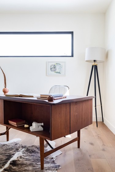 A wood desk on wood floor with a fur rug and a black-white floor lamp with Home Office Desk Ideas