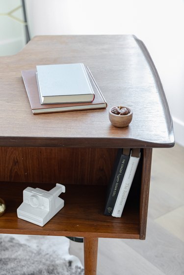 A wood desk with books