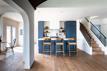 An open concept living space with wood flooring throughout