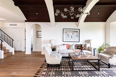 white living room with brown and white barrel ceiling