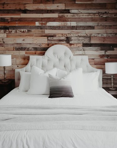 Farmhouse Chic Bedroom Ideas with Upholstered headboard with rustic wood paneling on wall