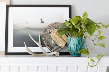 plant in green planter on white mantel