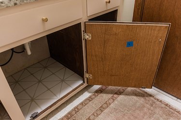 Open wood door of a bathroom vanity cabinet