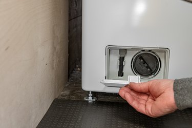 washing machine filter access door, opening access door
