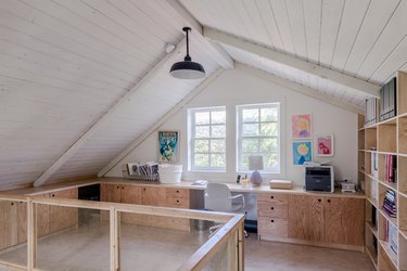 Scandinavian home office in attic with plywood furniture