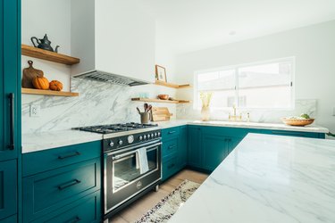 teal kitchen with marble countertop