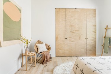 bedroom with green artwork and brown furniture