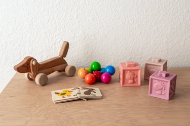 A wood dresser with toys, building blocks, and children's book