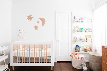 Nursery in small space, hanging shelves with books