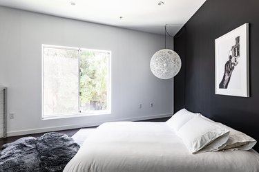 bedroom with bed and black wall for apartment decorating ideas