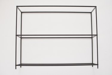 Black metal shelving frame against a white background