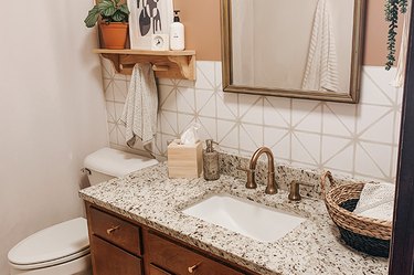 Neutral theme bathroom with peel-and-stick wallpaper over a vanity