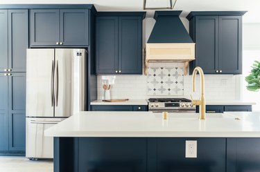 Deep blue kitchen with brass accents