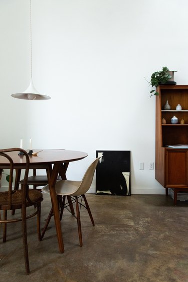 Mid-century modern dining room with round table and white hanging light