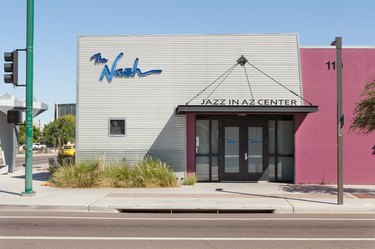 A gray-pink business with blue signage