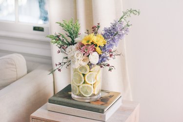 summer flower arrangement idea with pastel flowers and lemon slices in a vase