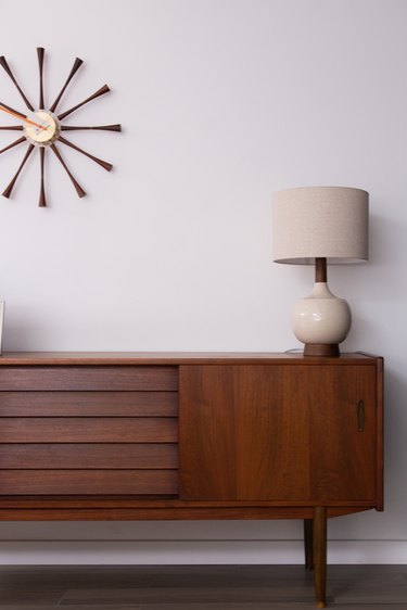 midcentury modern credenza, lamp, and wall clock