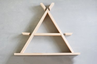 Unconstructed arranged a-frame shelf against grey background