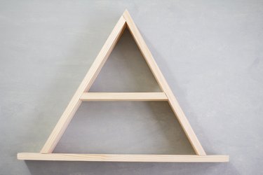 Wooden a-frame shelf against grey background