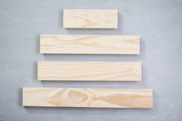 Four plywood panels against grey background