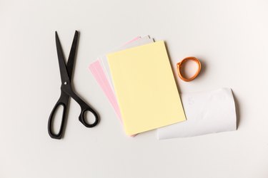 materials for making a diy advent calendar, including scissors, cord, and thick paper