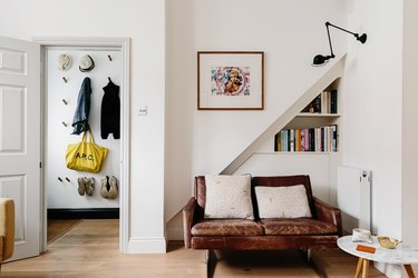 Living area with couch and peg organizer by door