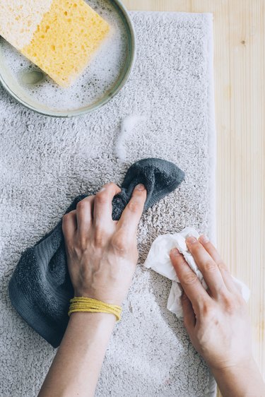 using a cloth towel to blot soapy residue