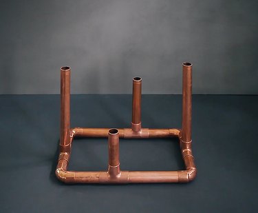 a candelabra base made from copper pipe
