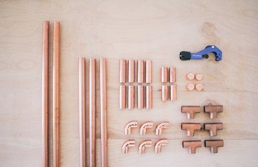 all the copper pieces needed for the clothing rack, including t-joints, elbow fittings, and end caps