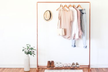 a clothing rack with a shoe rack attached made from copper pipe