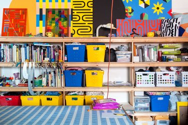 colorful office storage with bins on bookcase shelves