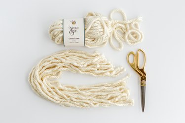 White yarn with gold scissors