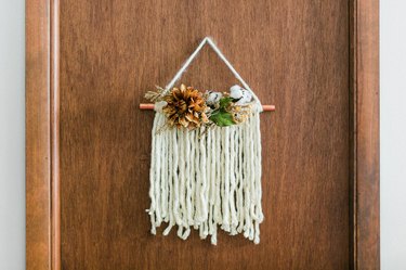 Thanksgiving door hanging with white yarn and faux flowers