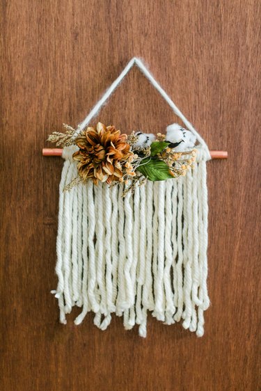 Thanksgiving door hanging with white yarn and faux flowers