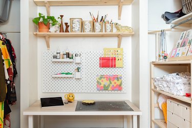 Craft Storage above White work desk with shelves and craft peg board