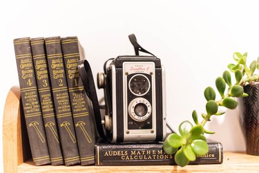 Antique camera and books on shelf