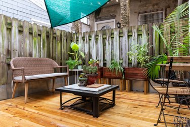 Wood deck with rattan sofa and black square table