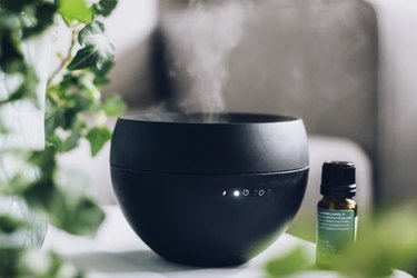 Black diffuser with container of essential oils