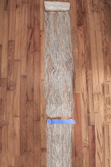 Neutral curtain fringe on wood floor