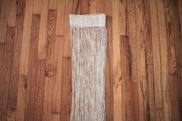 Neutral curtain fringe on wood floor