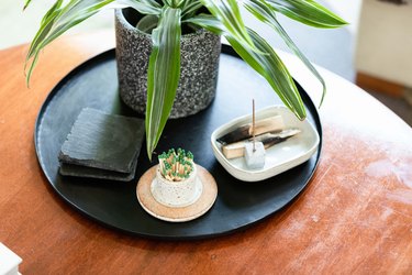 palo santo and black tray on wooden coffee table