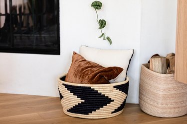 modern fireplace and pillows in woven basket