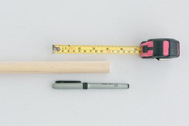 Measuring tape with pen and wood dowel