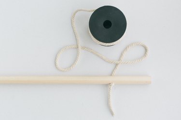 Wood dowel with spool of rope