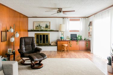Living room with leather and wood mid-century furniture and wood walls