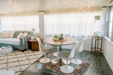 Family room with gray and beige furniture with large curtained windows