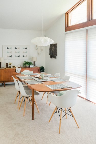 Dining room with large windows mid-century dining furniture and pendant lantern