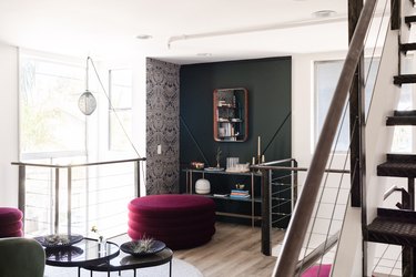 a living room with large burgundy poufs