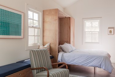 converted garage bedroom idea with murphy bed and arm chair